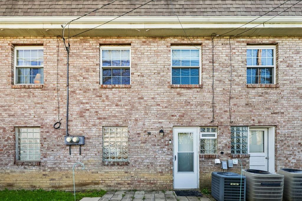 239 Whitestown Village, Unit F Butler, PA 16001 - Photo 33 of 40 a brick building with a bench and windows