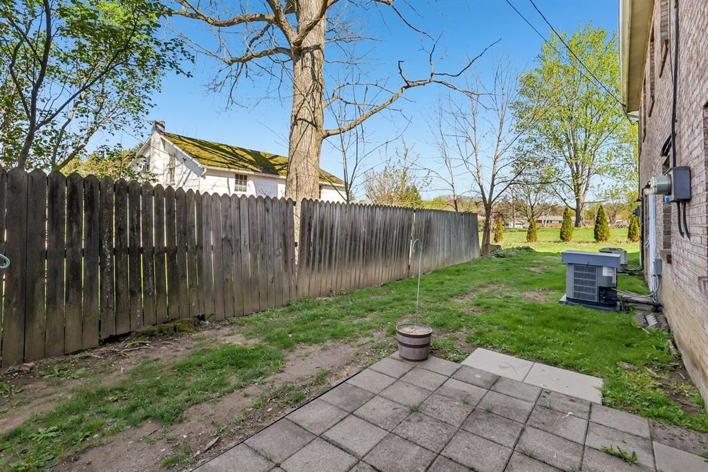239 Whitestown Village, Unit F Butler, PA 16001 - Photo 36 of 40 a view of backyard with table and chairs and wooden fence