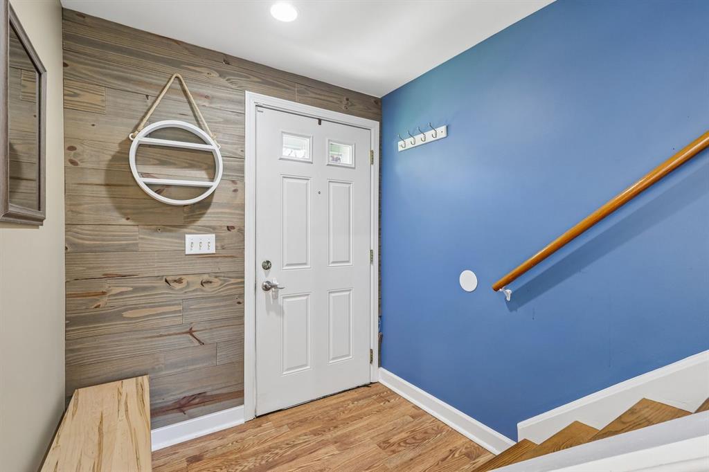239 Whitestown Village, Unit F Butler, PA 16001 - Photo 5 of 40 a view of a hallway with wooden floor and front door