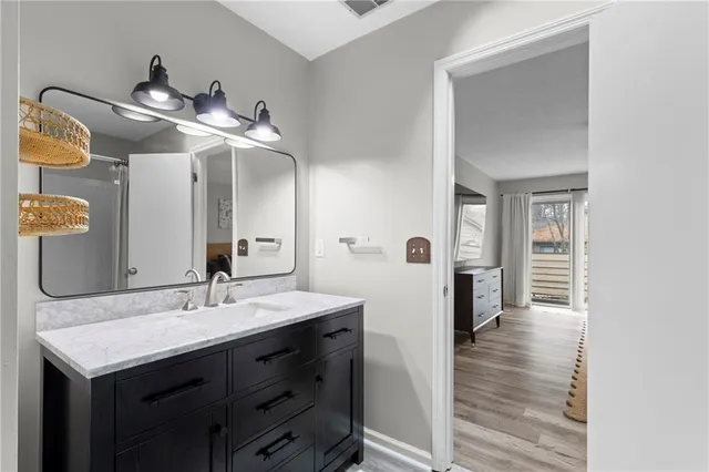 a bathroom with a sink a mirror and a shower