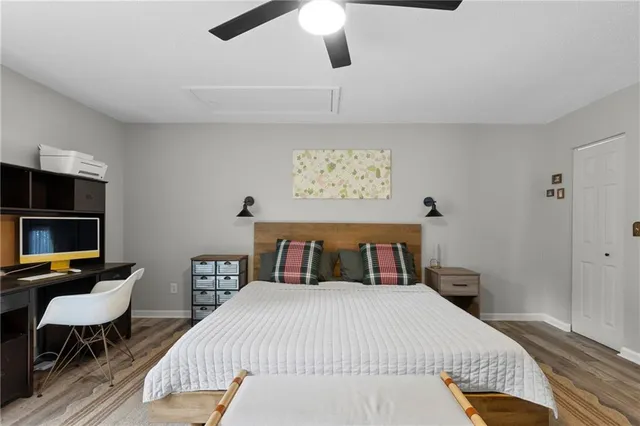 a bedroom with a bed and wooden floor