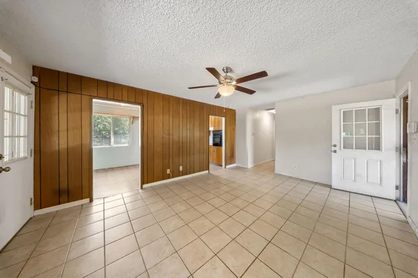 a view of an empty room with window and cabinet