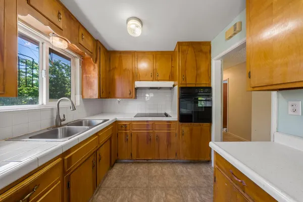 a kitchen with a sink and large cabinets