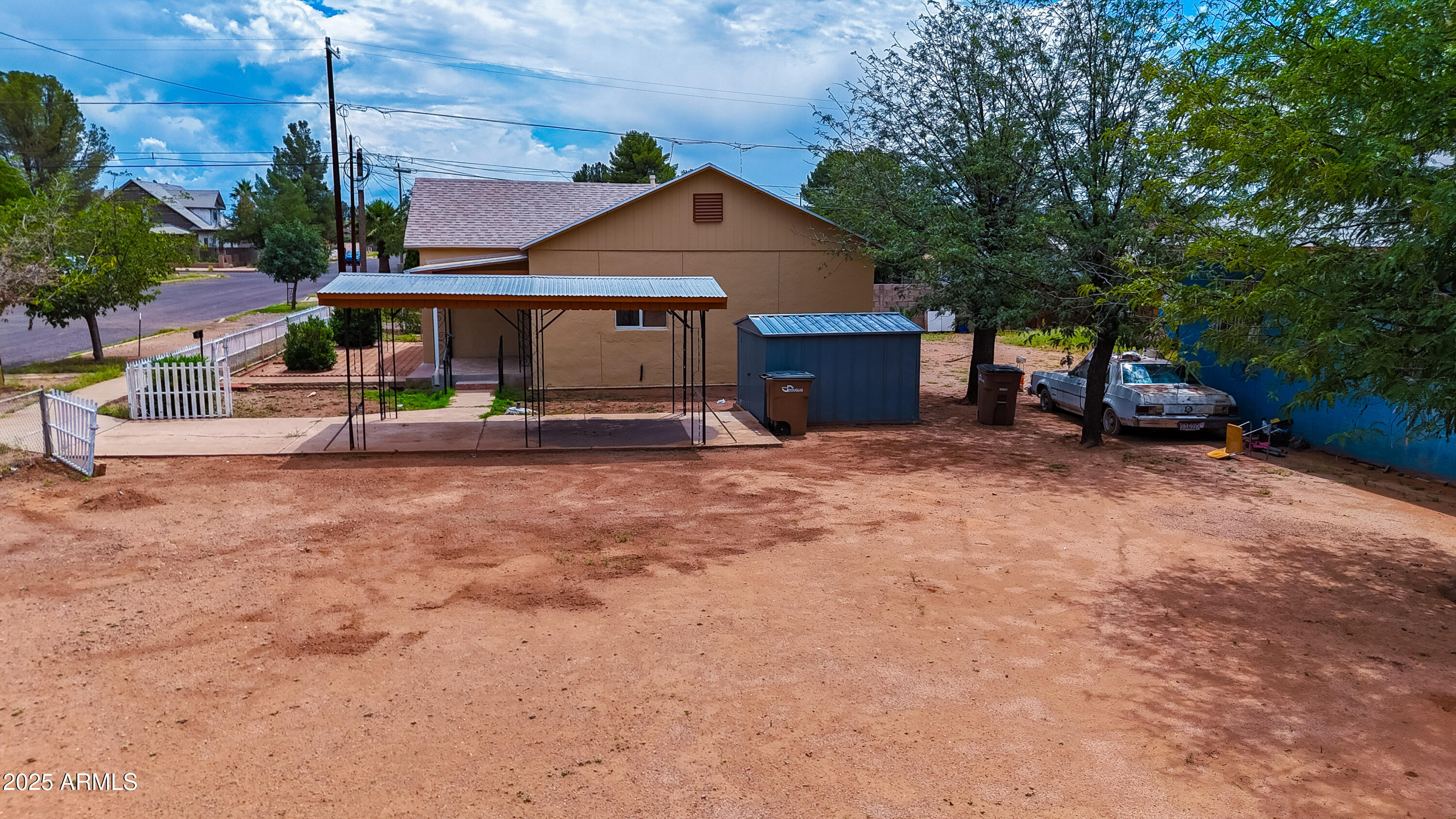 660 B Avenue Douglas, AZ 85607 - Photo 25 of 32 a view of a house with large trees and wooden fence