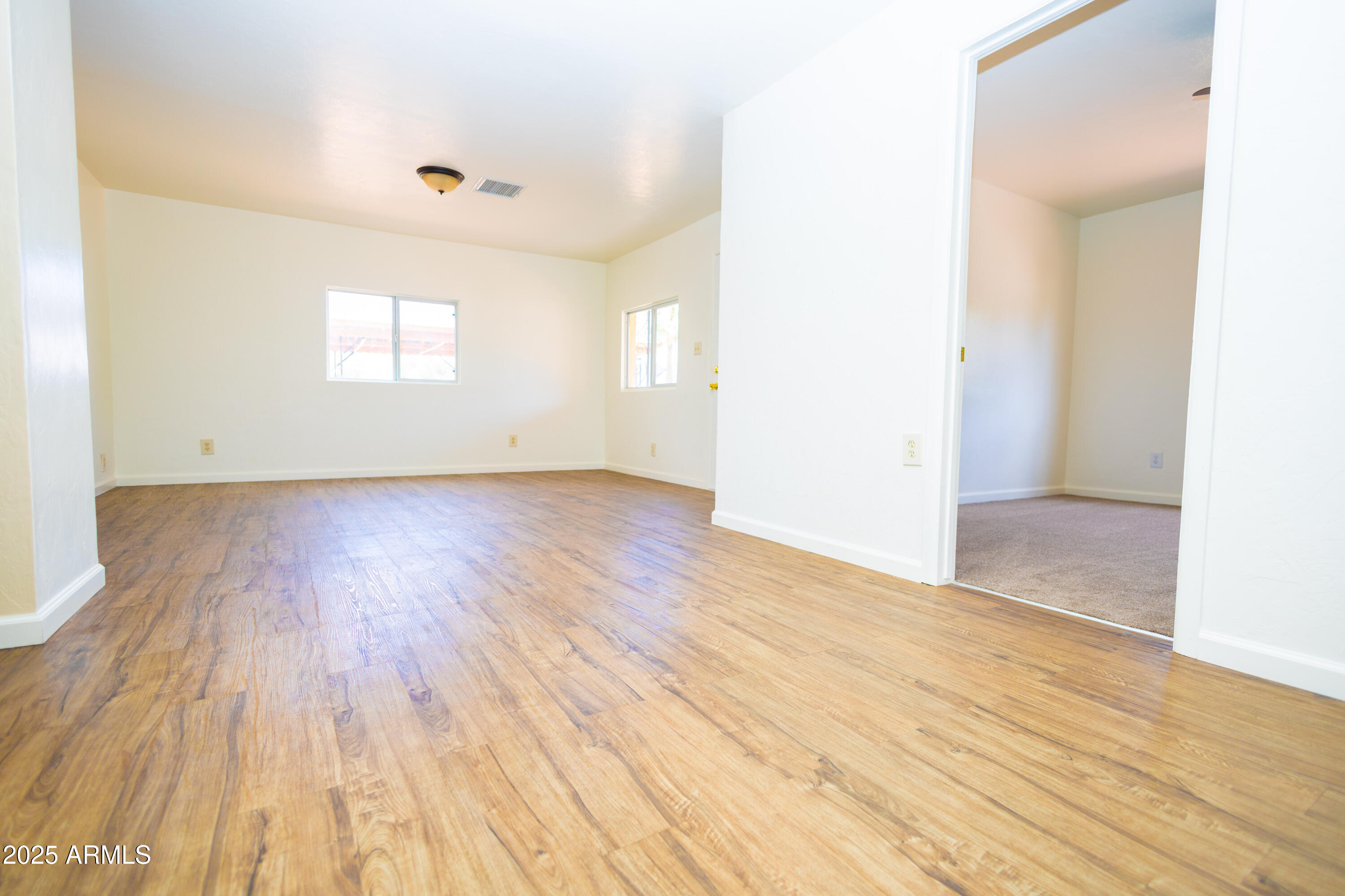 660 B Avenue Douglas, AZ 85607 - Photo 10 of 32 an empty room with wooden floor and windows