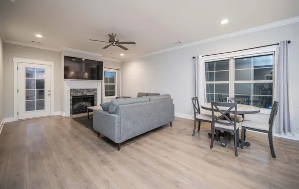 a living room with furniture a fireplace and a flat screen tv