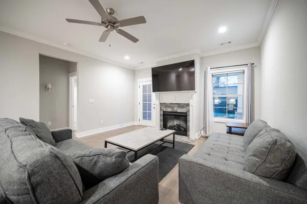 a living room with furniture fireplace and a flat screen tv