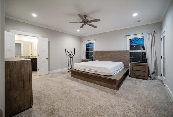a bedroom with a bed and dresser with mirror