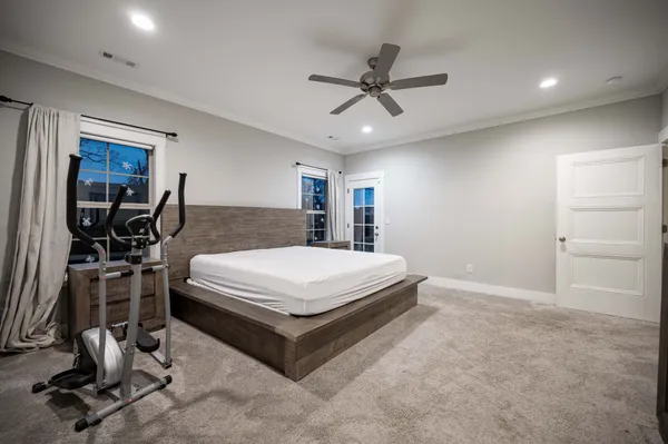 a spacious bedroom with a bed a desk and chair