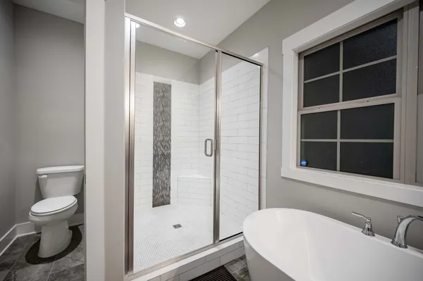 a bathroom with a toilet and a shower
