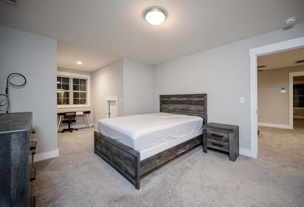 a bedroom with a bed and a chair