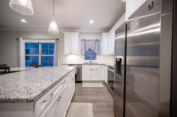 a kitchen with a sink stove and refrigerator