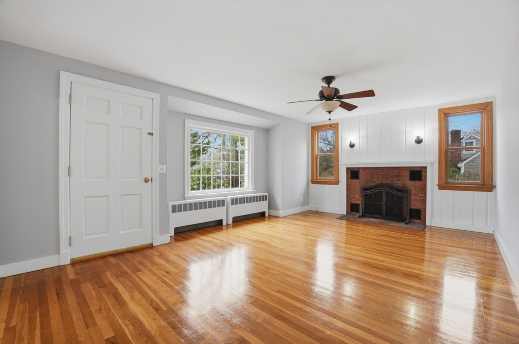 590 Sandwich Road Falmouth, MA 02536 - Photo 12 of 42 a view of empty room with wooden floor and fireplace