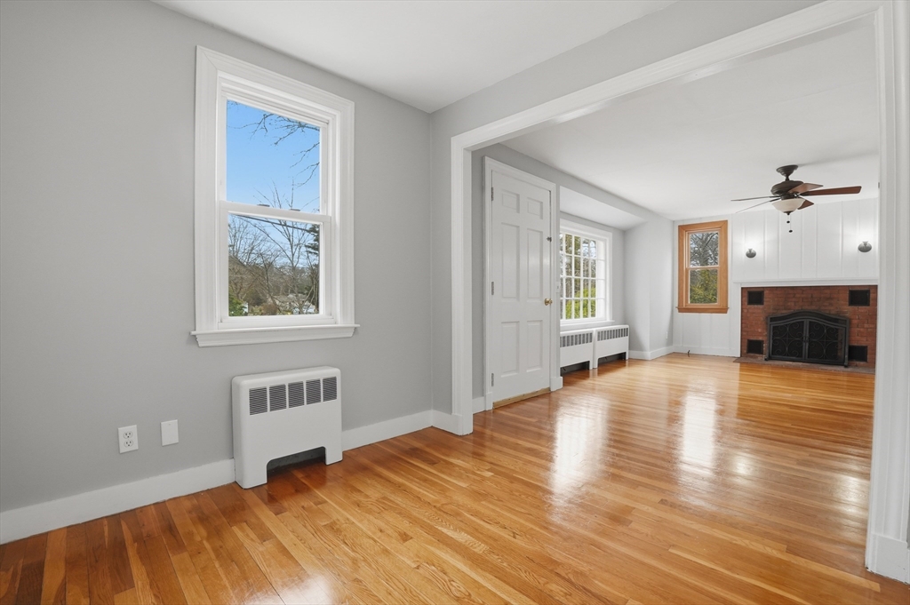 590 Sandwich Road Falmouth, MA 02536 - Photo 14 of 42 a view of a livingroom with wooden floor and a fireplace