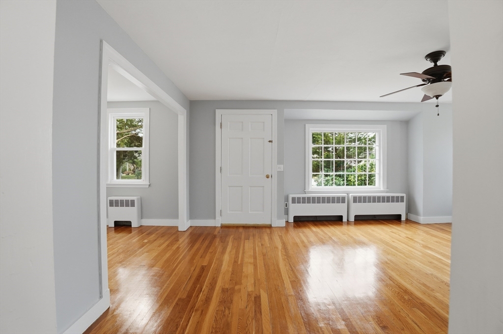 590 Sandwich Road Falmouth, MA 02536 - Photo 16 of 42 an empty room with wooden floor and windows
