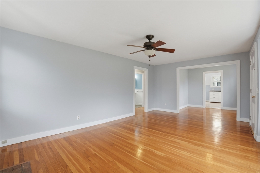 590 Sandwich Road Falmouth, MA 02536 - Photo 18 of 42 a view of an empty room with window and wooden floor