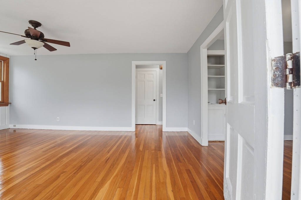 590 Sandwich Road Falmouth, MA 02536 - Photo 19 of 42 a view of empty room with wooden floor and fan