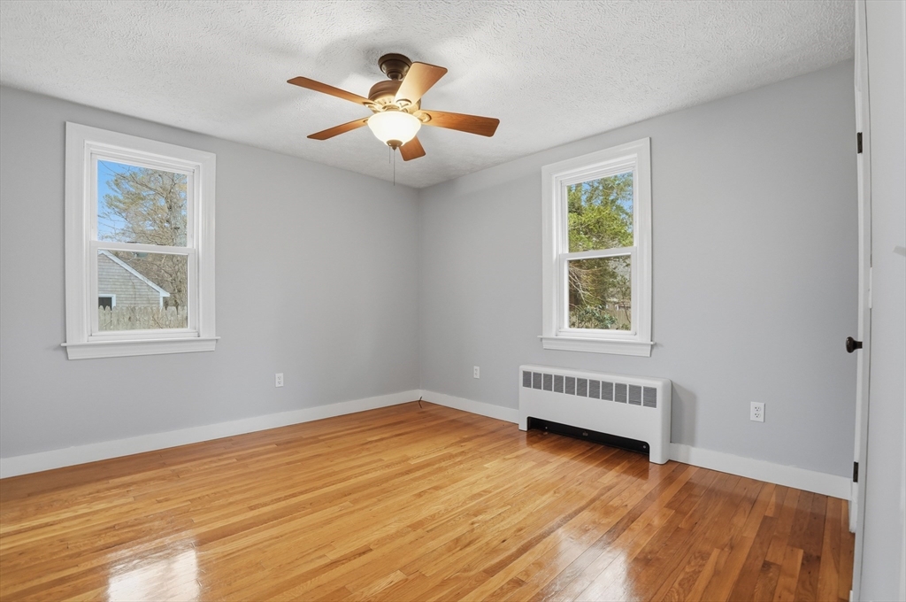 590 Sandwich Road Falmouth, MA 02536 - Photo 26 of 42 a view of an empty room with wooden floor and a window
