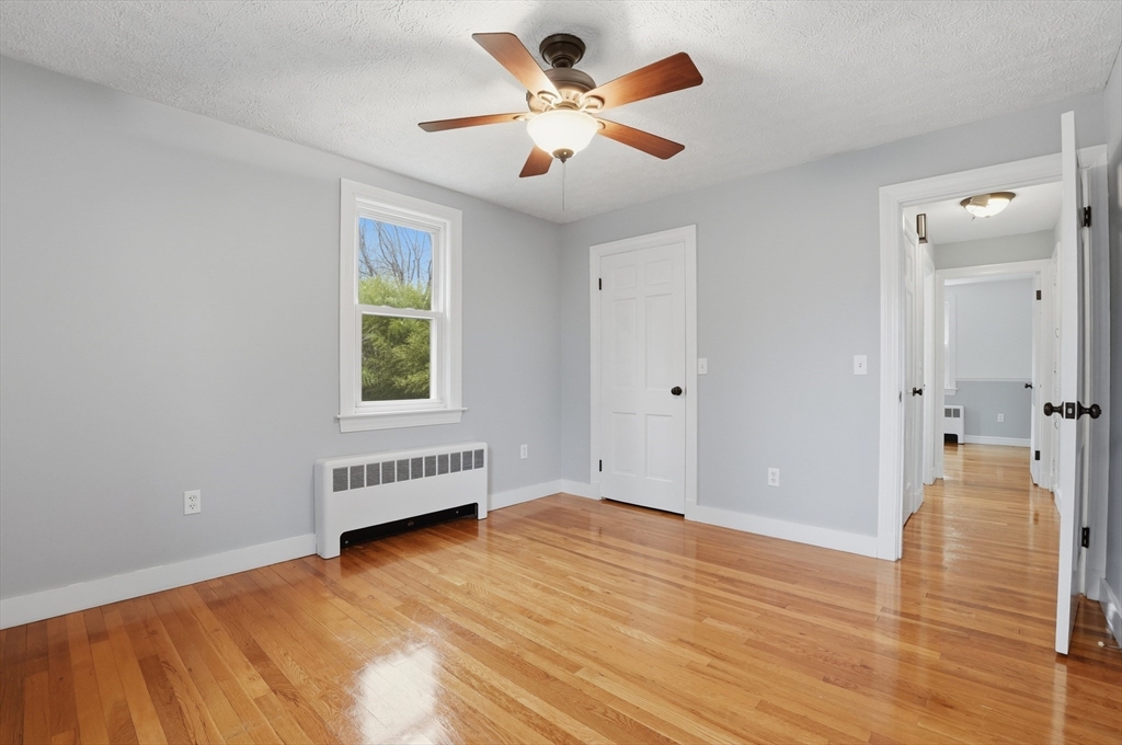 590 Sandwich Road Falmouth, MA 02536 - Photo 27 of 42 a view of an empty room and window with wooden floor