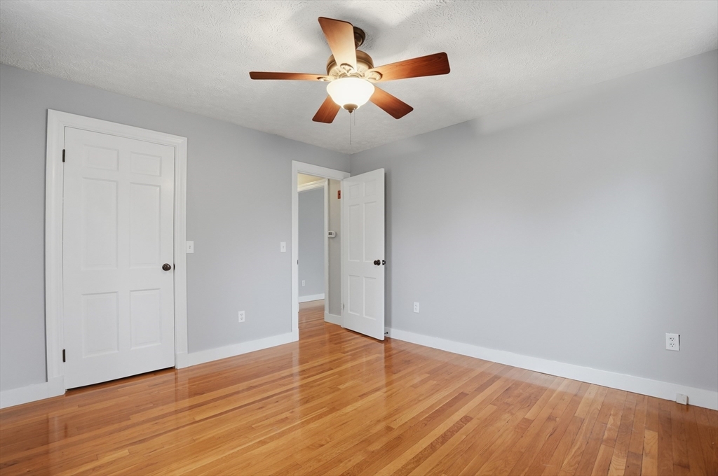 590 Sandwich Road Falmouth, MA 02536 - Photo 28 of 42 a view of an empty room with wooden floor