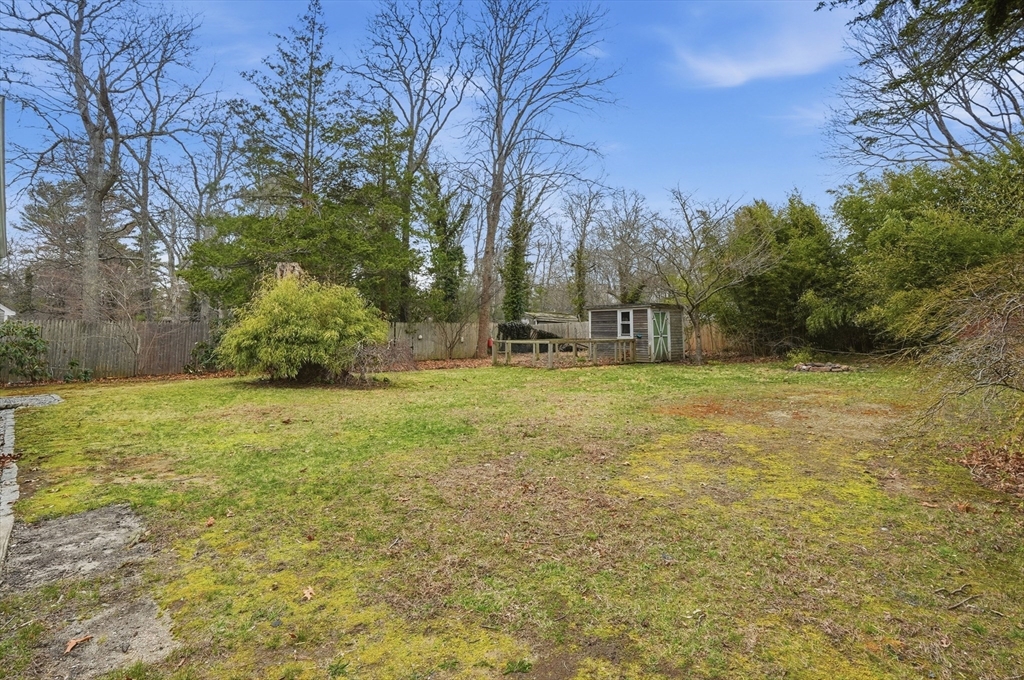 590 Sandwich Road Falmouth, MA 02536 - Photo 37 of 42 a backyard of a house with lots of green space
