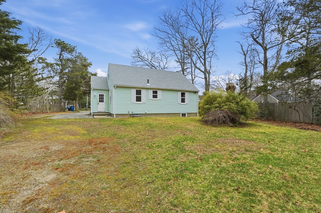 590 Sandwich Road Falmouth, MA 02536 - Photo 39 of 42 a large tree in front of yellow house