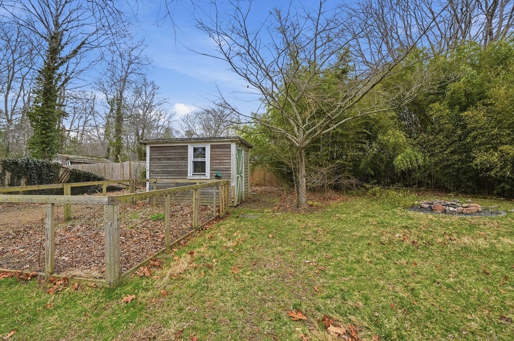 590 Sandwich Road Falmouth, MA 02536 - Photo 40 of 42 a backyard of a house with lots of green space