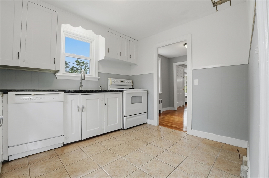 590 Sandwich Road Falmouth, MA 02536 - Photo 4 of 42 a kitchen with white cabinets and sink