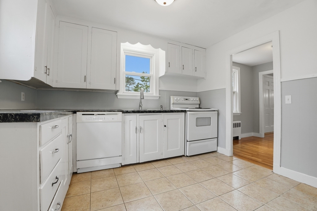 590 Sandwich Road Falmouth, MA 02536 - Photo 5 of 42 a kitchen with granite countertop a sink and white cabinets