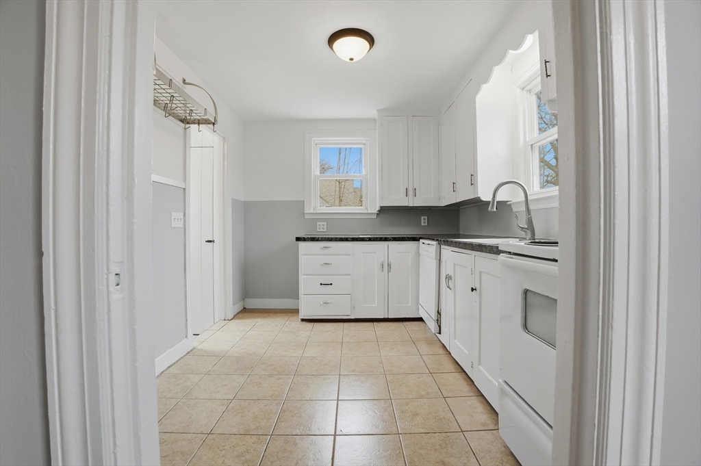 590 Sandwich Road Falmouth, MA 02536 - Photo 6 of 42 a kitchen with granite countertop a sink and cabinets