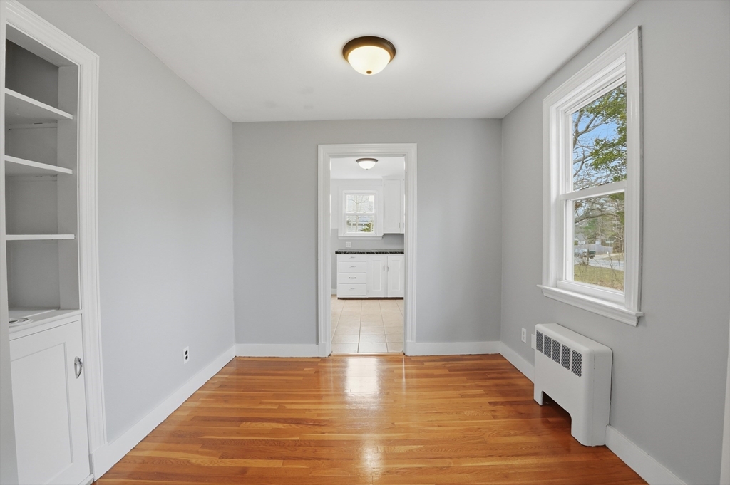 590 Sandwich Road Falmouth, MA 02536 - Photo 8 of 42 a view of an empty room with window and wooden floor