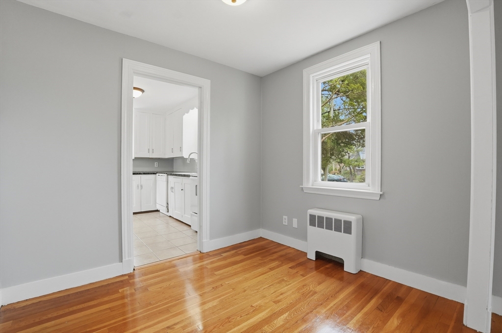 590 Sandwich Road Falmouth, MA 02536 - Photo 10 of 42 an empty room with wooden floor and windows