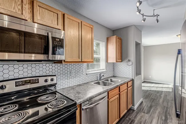 a kitchen with stainless steel appliances granite countertop a stove and a microwave