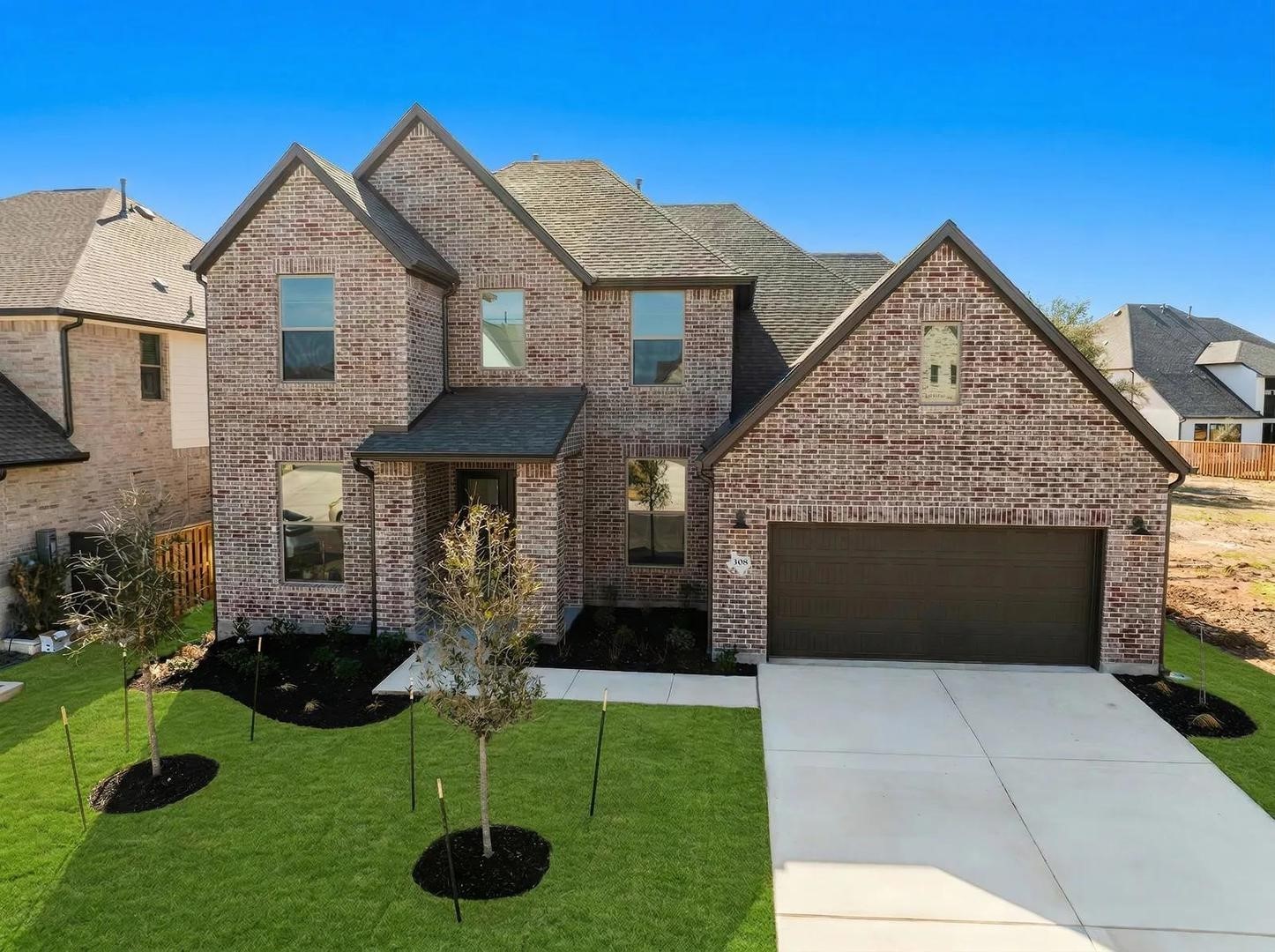 a front view of a house with a yard and garage