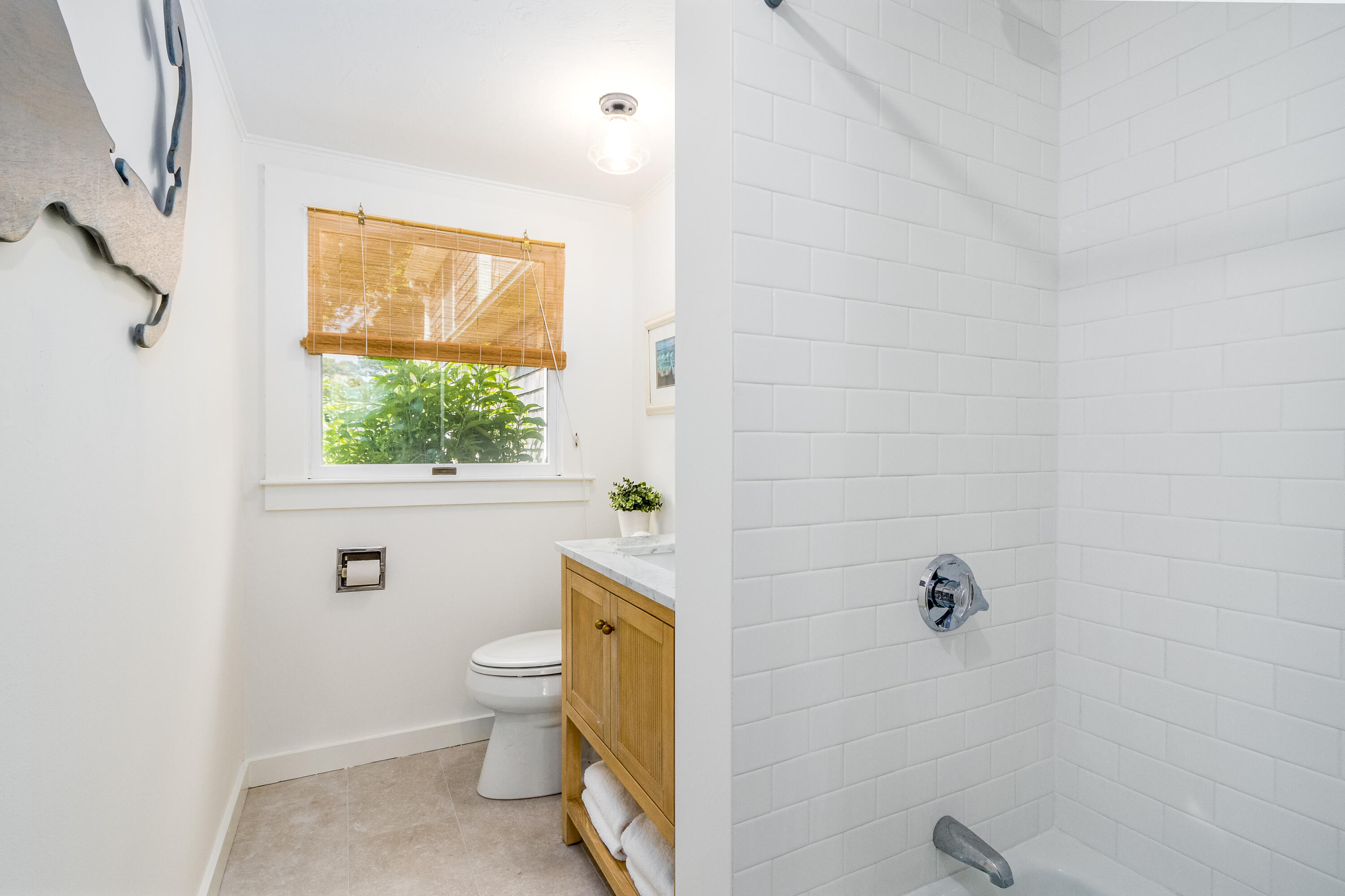 429 Paine's Creek Road Brewster, MA 02631 - Photo 7 of 35 a bathroom with a granite countertop toilet a sink and a window