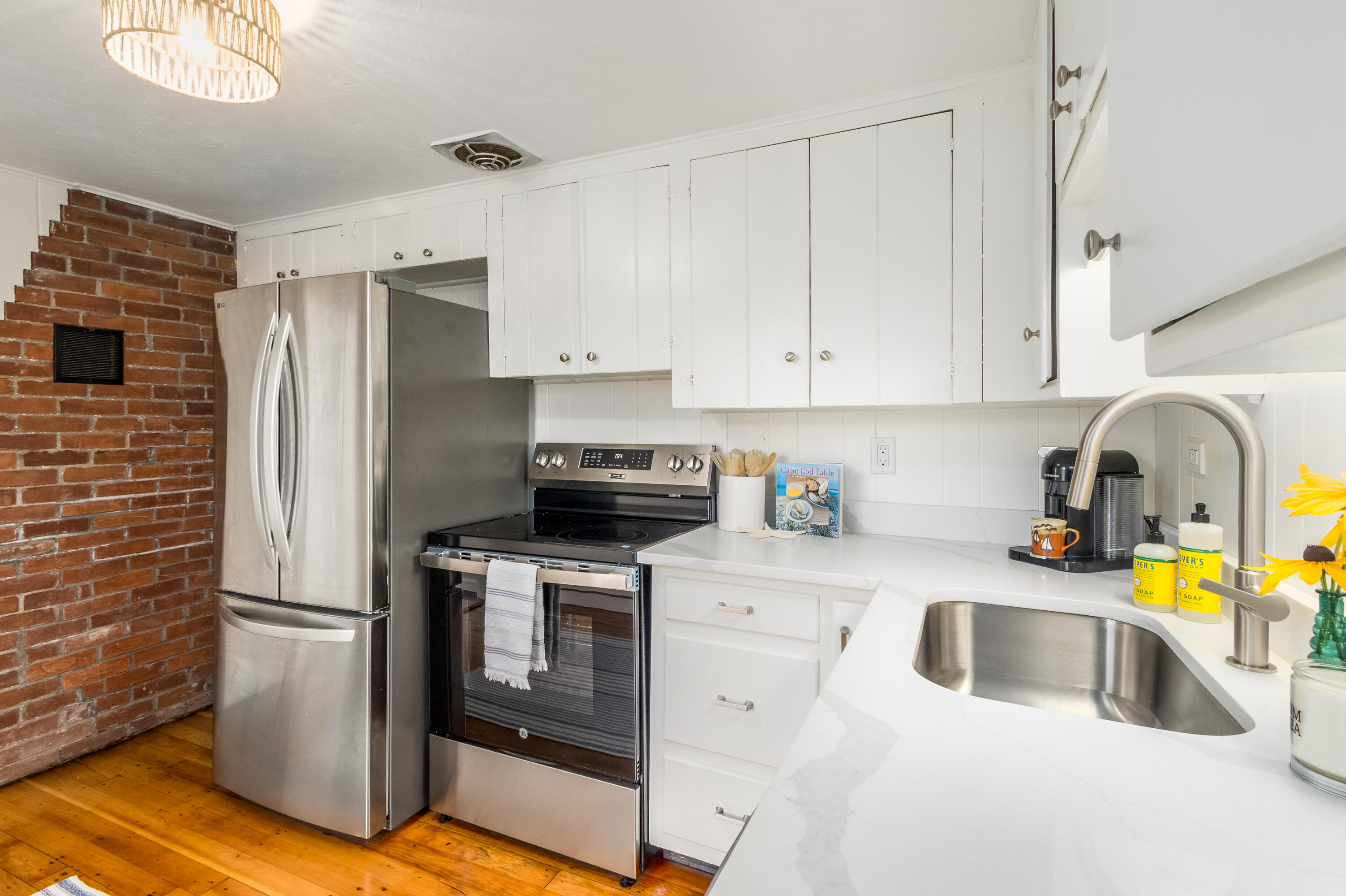 429 Paine's Creek Road Brewster, MA 02631 - Photo 9 of 35 a kitchen with a sink cabinets and stainless steel appliances
