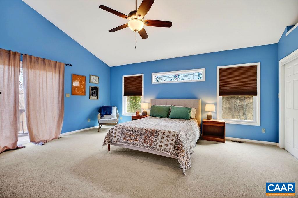 62 Summit Court Roseland, VA 22967 - Photo 20 of 75 a bedroom with a bed chandelier and a window