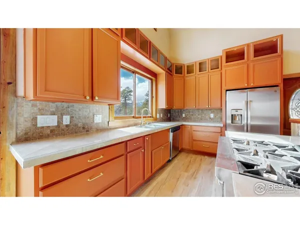 a open kitchen with stainless steel appliances granite countertop a sink stove and refrigerator