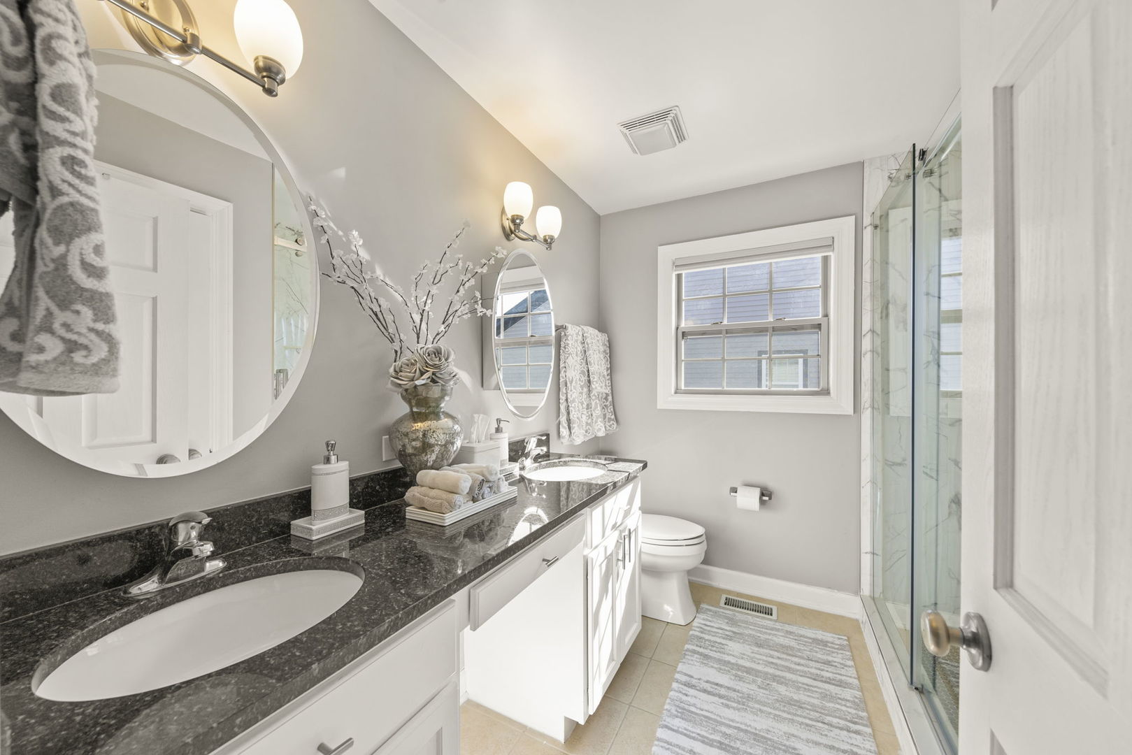 16441 Mueller Circle Plainfield, IL 60586 - Photo 29 of 50 a bathroom with double vanity sinks a mirror and a toilet
