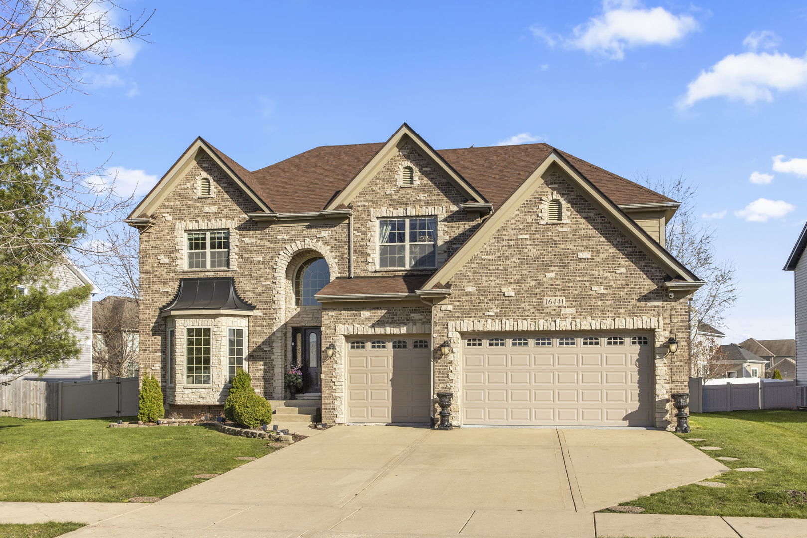 16441 Mueller Circle Plainfield, IL 60586 - Photo 3 of 50 a front view of a house with a yard and garage