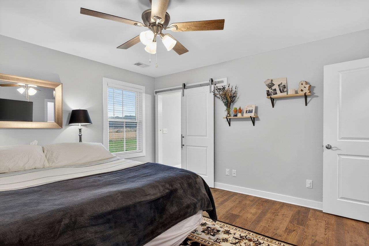 106 16th Street Grottoes, VA 24441 - Photo 21 of 71 a bedroom with a large bed and a chandelier