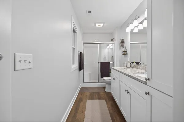a bedroom with a bed and a dresser in it