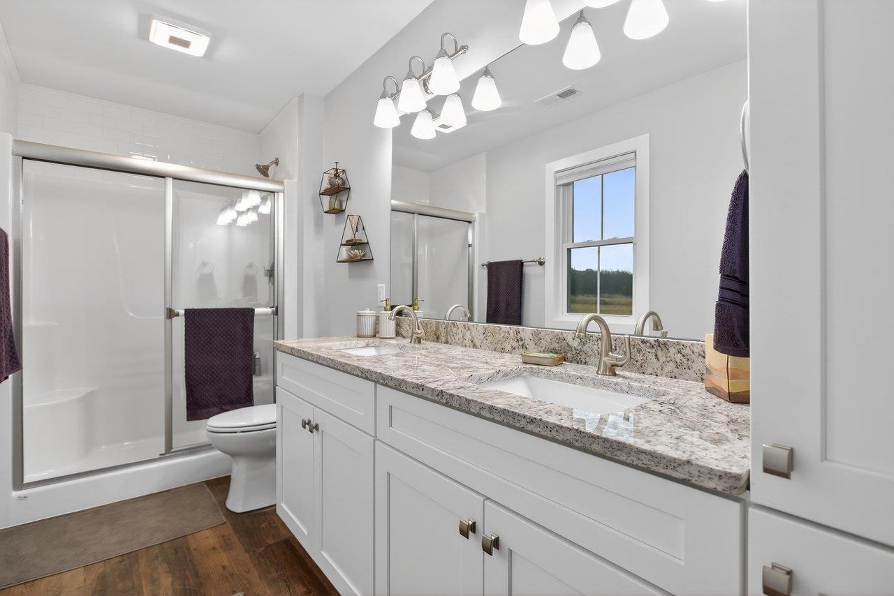 106 16th Street Grottoes, VA 24441 - Photo 24 of 71 a bathroom with a granite countertop double vanity sink toilet and shower