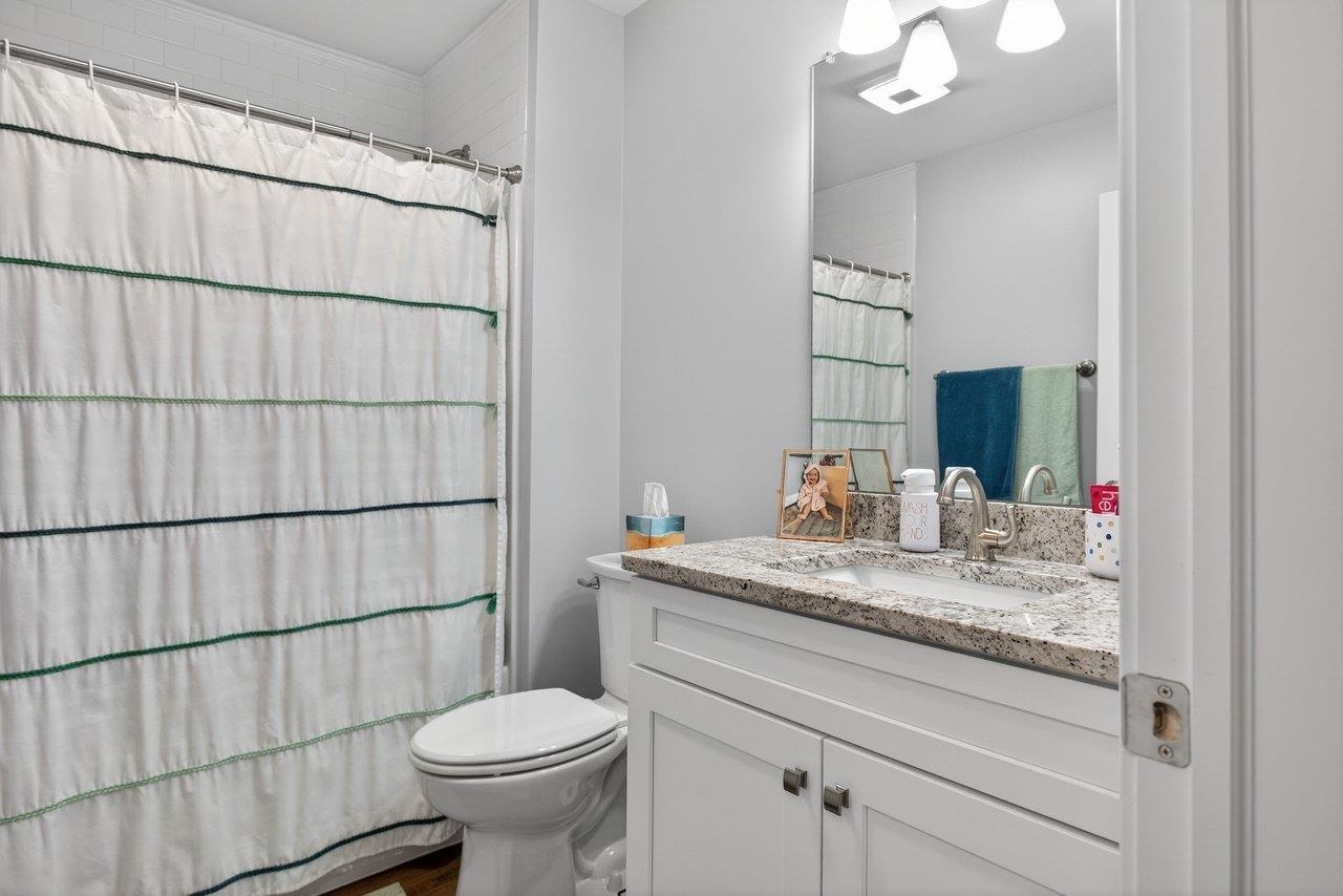 106 16th Street Grottoes, VA 24441 - Photo 29 of 71 a bathroom with a granite countertop sink a toilet and mirror