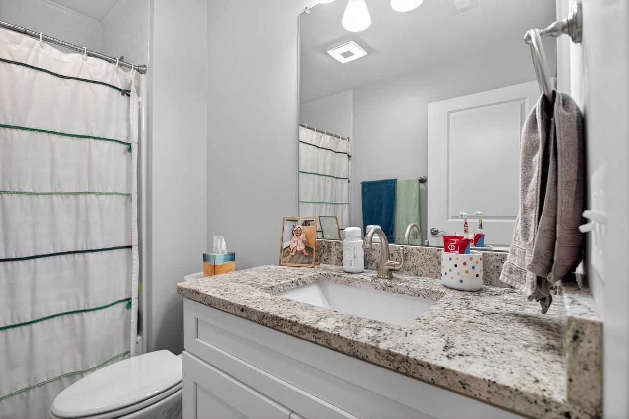 106 16th Street Grottoes, VA 24441 - Photo 30 of 71 a bathroom with a granite countertop sink toilet and mirror