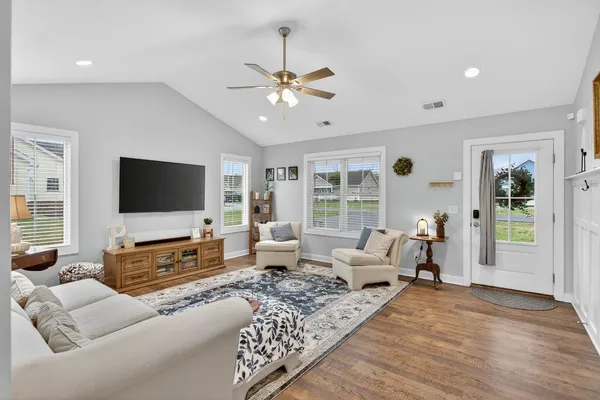 a living room with furniture and a flat screen tv