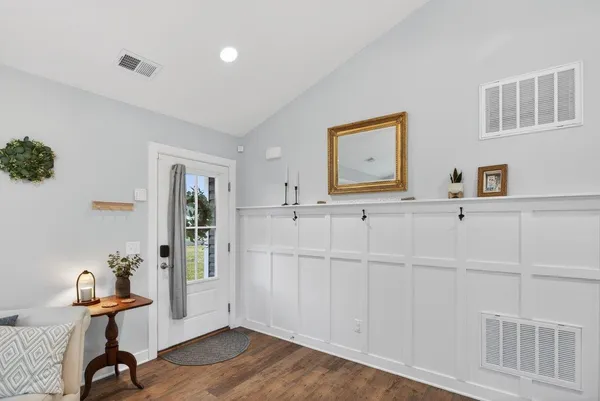 a view of a dining room with furniture and chandelier