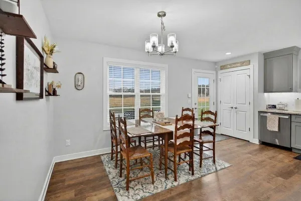 a view of a dining room with furniture and chandelier