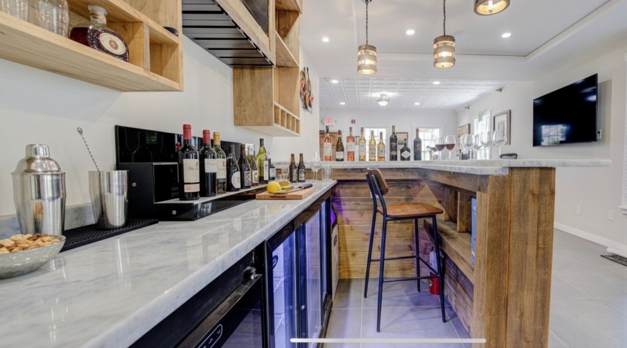 29 Cuna Street St. Augustine, FL 32084 - Photo 18 of 69 Indoor dry bar with light stone countertops, light tile patterned floors, recessed lighting, decorative light fixtures, and wine cooler