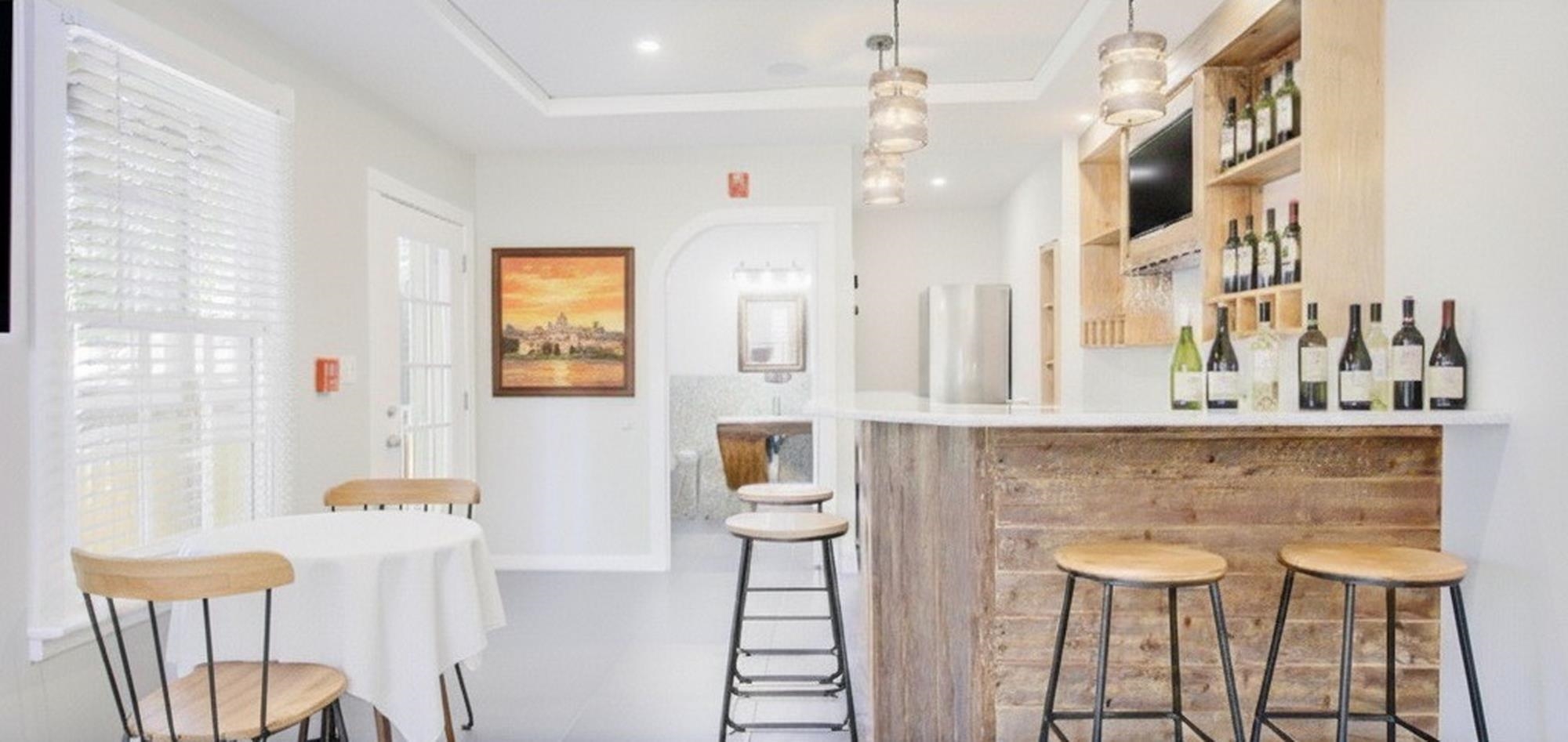 29 Cuna Street St. Augustine, FL 32084 - Photo 19 of 69 Indoor dry bar with open shelves, freestanding refrigerator, pendant lighting, and light countertops